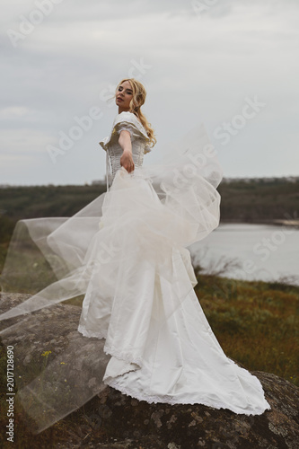 Bride with bouquet outdoors. Lifestyle and wedding concept.