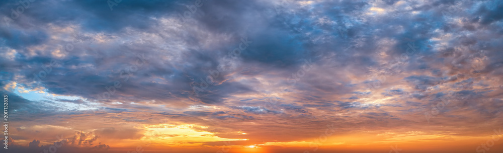 Fototapeta premium Panorama of a dramatic, tropical sunset sky as a background or texture