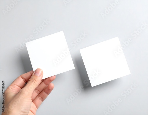Hand Holding Two Blank Square Business Cards on Soft Light Background Minimal Branding Mockup