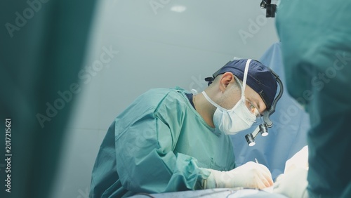 Leading surgeon man doctor suture patient incision with surgical medical thread using medicine instruments group of nurses assisting nursing operation male practitioner working health care clinic
