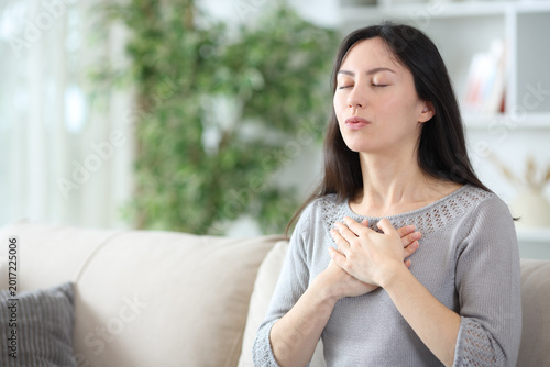 Asian woman exhaling doing breathing exercise