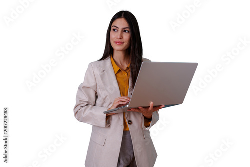 Foto Businesswoman standing, holding laptop, looking away with thoughtful expression,