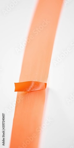 Macro shot of a single piece of brightly colored tape, its adhesive edge visible,  playful,  accenting