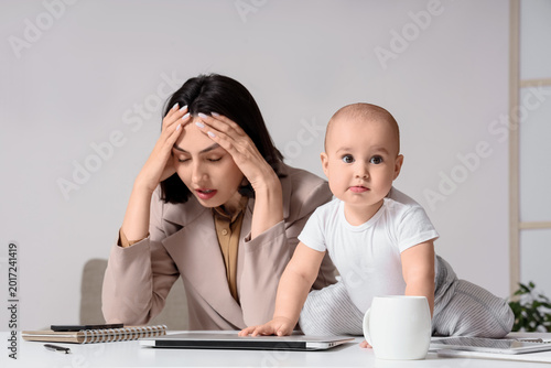 Stressed businesswoman with...