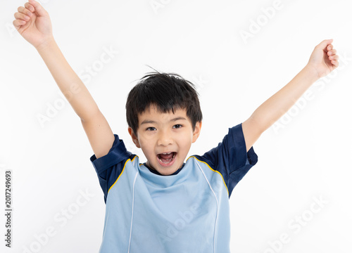 Happy boy in  t-shirt raising hands up