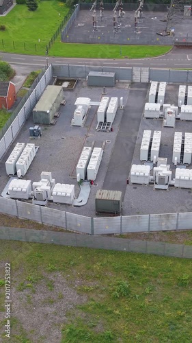 Top Down Aerial View of BESS Battery Energy Storage Containers near Electrical Substation. Renewable Power Solutions for the Grid in UK. Vertical Video.