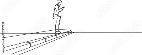 Konstfotografi Man with smartphone standing on edge of platform, looking down