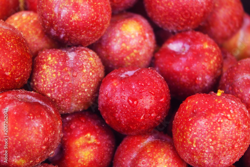 Many fresh plums close up as background
