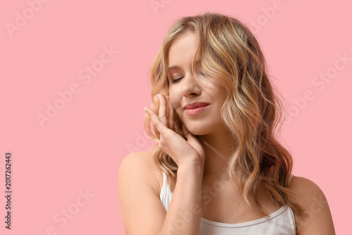 Blonde young woman with cur...
