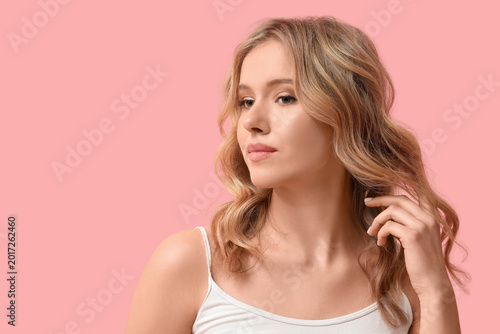 Blonde young woman with cur...