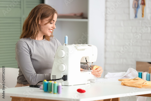 Female tailor using sewing ...