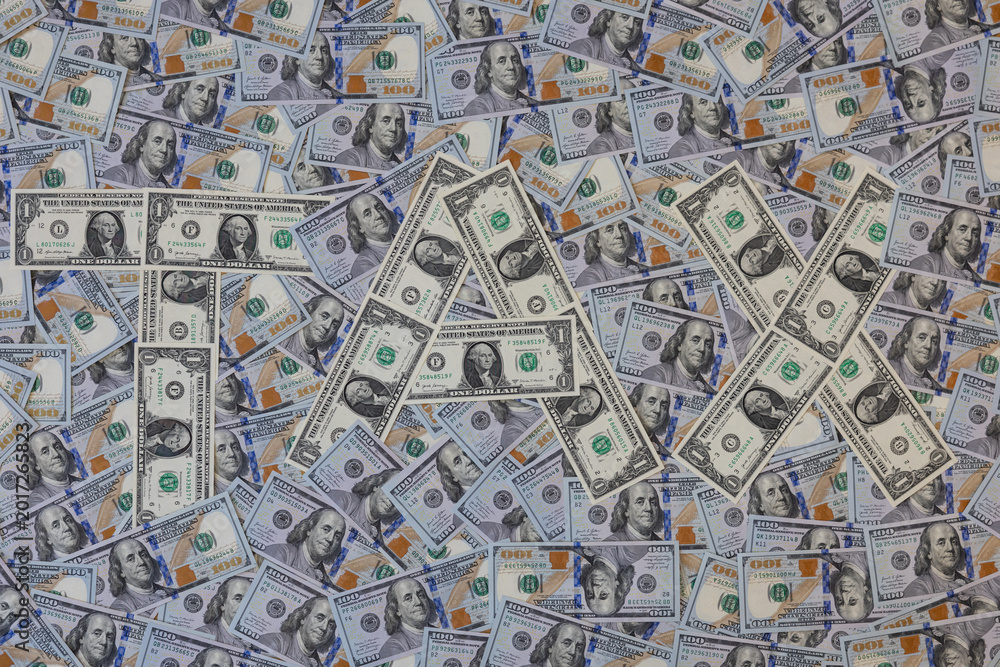 Fototapeta premium Word TAX made of one dollar bills on hundred US dollar banknotes background