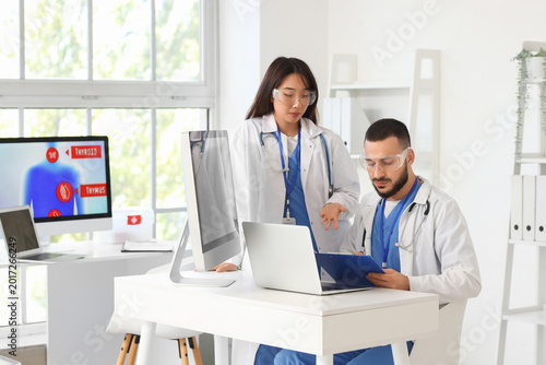 Doctors analyzing scientific data at desk in laboratory