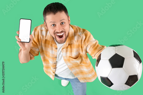 Happy young man with soccer...