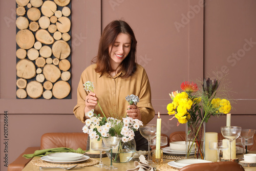 Young happy woman serving t...