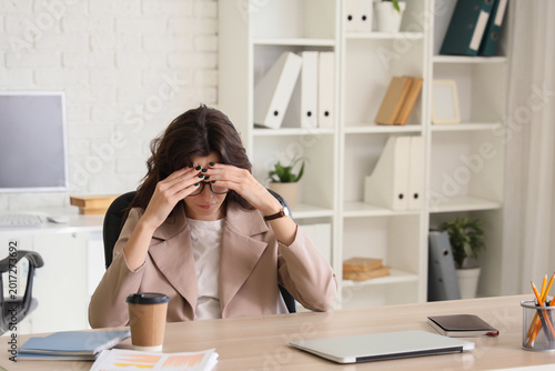 Tired young businesswoman w...