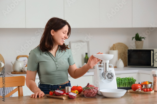 Young woman with meat grind...