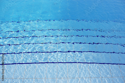 Blue pool filled with water in Summer