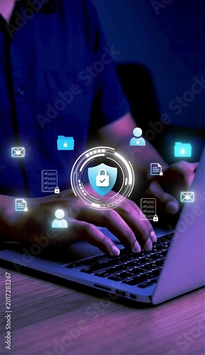 A businessman works on his laptop at home with a virtual display showing a symbol to signify cyber security privacy and online data protection 