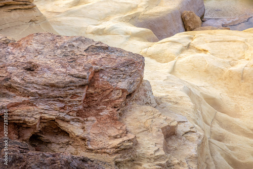 Dramatic layered rock formations create a stunning geological mosaic. A powerful geological terrain backdrop with deep shadows and clear lines.
