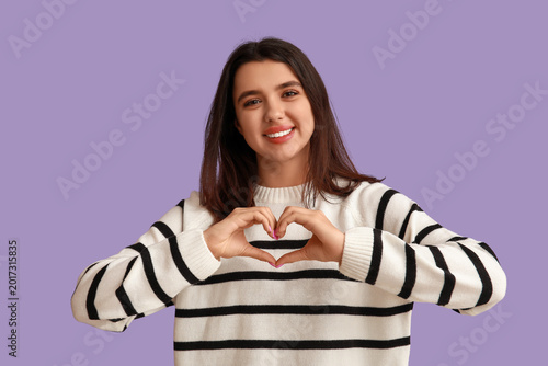 Happy young girl showing he...