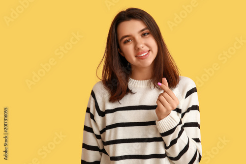 Happy young girl showing he...