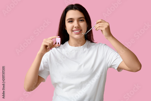 Female dentist with tool an...