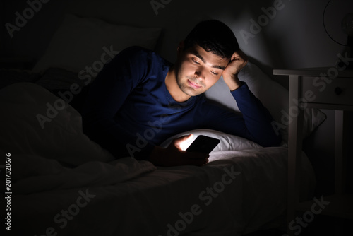 Young man using mobile phon...