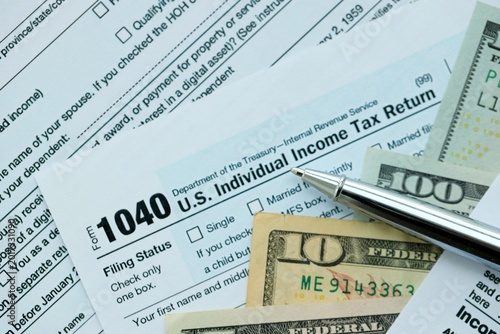 Bilde på lerret 1040 Individual Income tax return form and pen with dollars money bills on accou