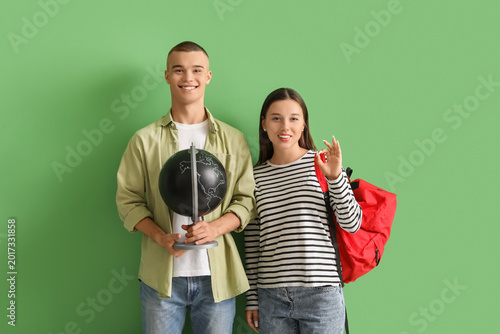 Happy students with backpac...