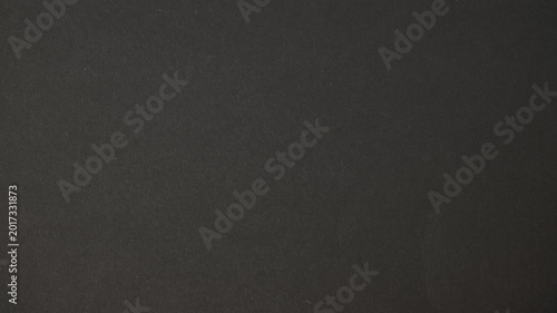 Looping retro-style black paper texture animation with subtle flicker and film grain. Vintage cinematic background for overlays, titles, and motion graphics.