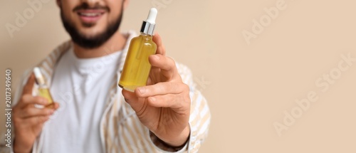Young man holding bottles o...