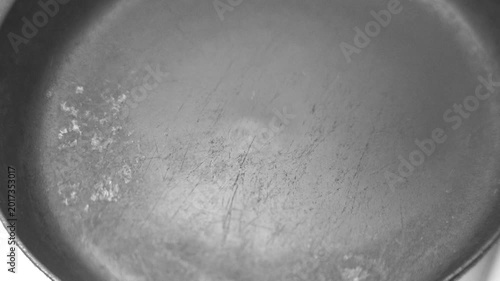 pour oil into a hot frying pan on an electric stove