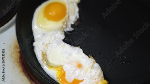 making fried eggs for breakfast