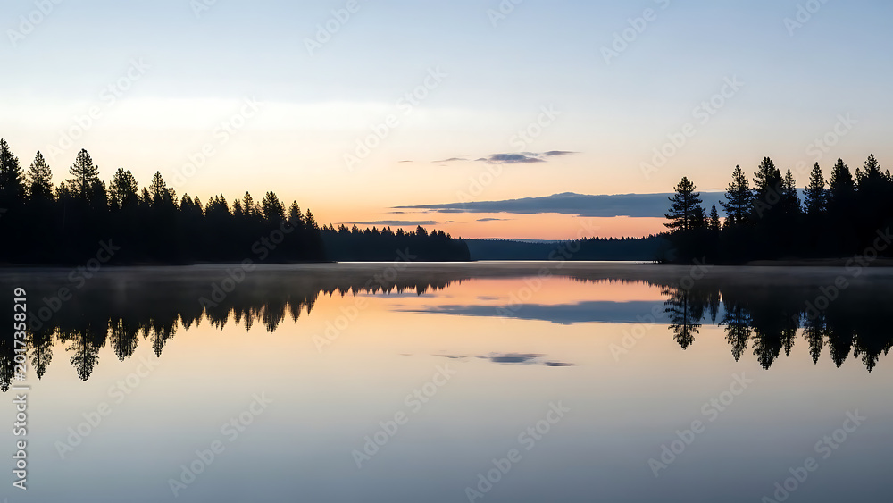 Fototapeta premium Serene dawn reflection on a mirror lake. 