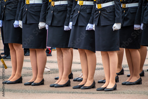 Foto Low section view female cadets wearing black formal skirts with white belts and