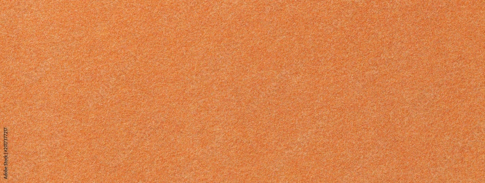 Fototapeta premium Orange suede fabric background with matte microfiber texture, soft apricot felt surface, macro