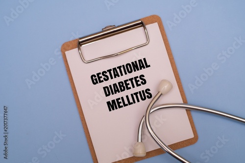 Tableau sur toile A clipboard with GESTATIONAL DIABETES MELLITUS text and stethoscope on a coloured background