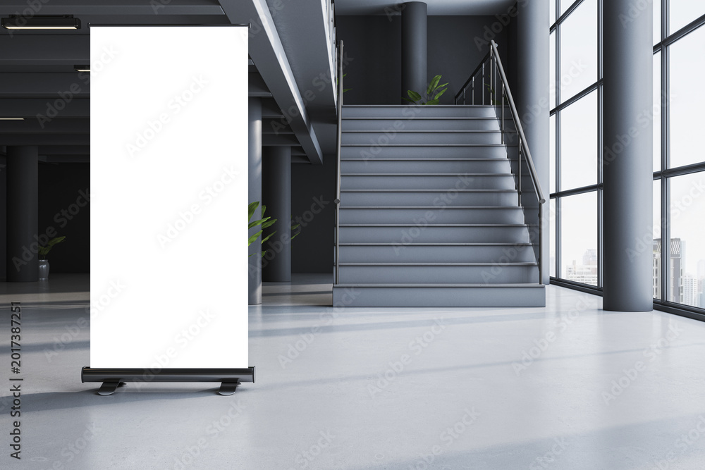 Fototapeta premium Blank rollup banner mockup standing in modern interior hallway with stairs and large windows in clean contemporary building space. 3D Rendering