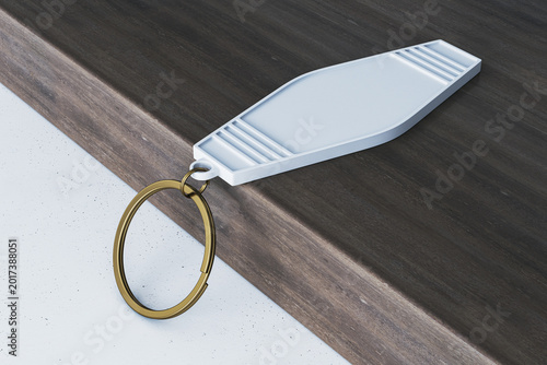 Blank keychain mockup on wooden surface with metallic ring showcased as clean...