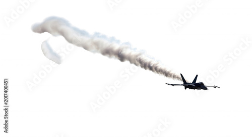 A military fighter jet flying through the sky leaving a thick, swirling white vapor trail against a solid black background