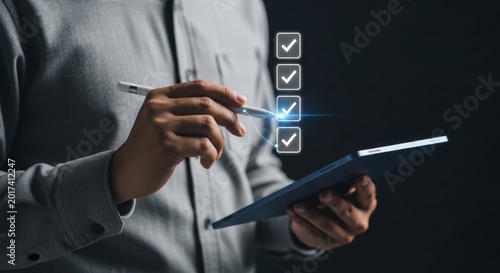 Professional hand digitally marking a checklist on a tablet, symbolizing project completion and business productivity