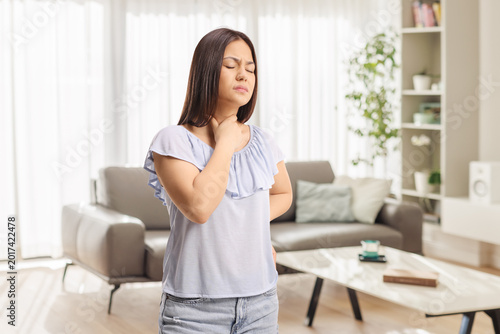Young woman with pain in her throat