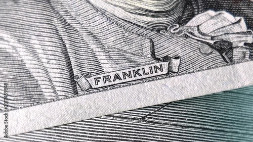 Franklin name on one hundred dollar bill macro close up rotating camera movement us currency finance concept