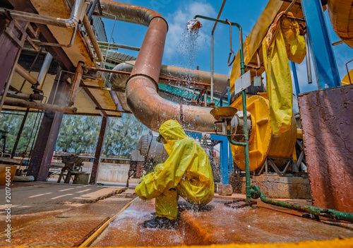 Fotografija Male workers dressing in protective shower detoxification suit clean up after se