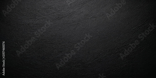 A dark grunge black and white textured background features a rough grey material pattern resembling old vintage leather and wrinkled paper surface wallpaper