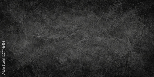 Fotografie A dark grunge texture featuring a black paper surface and an old vintage chalkbo