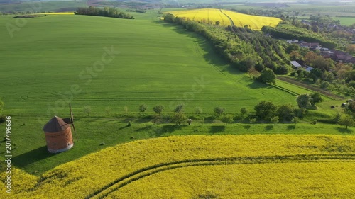 Aerial view of amazing wavy hills with agricultural fields near  Chvalkovice windmill, South Moravia, Czech Republic, Europe