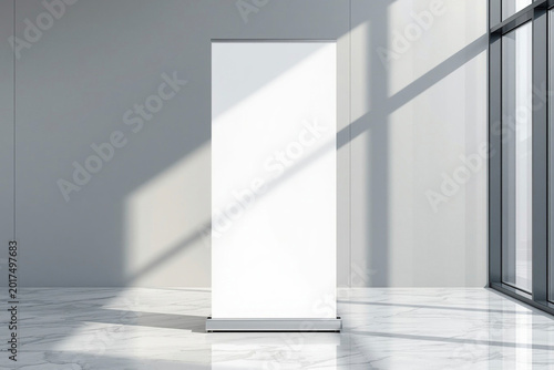 Roll up banner standee mockup standing upright on a smooth light grey wall in a modern corporate office lobby, plain white banner surface without text,