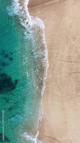 Shot looking straight down at the waves along the beach on the northshore island of Oahu in Hawaii.